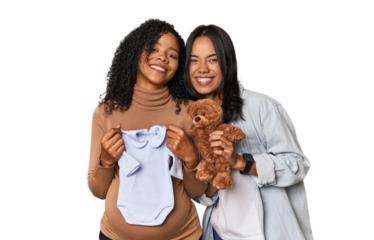 Two Latin women, one pregnant, with teddy bear in studio