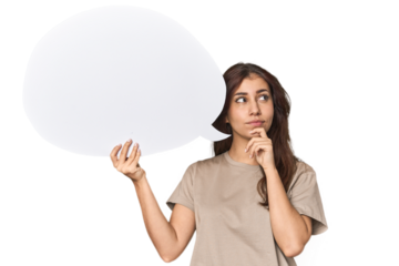 Middle Eastern woman holding comic bubble looking sideways with doubtful and skeptical expression.