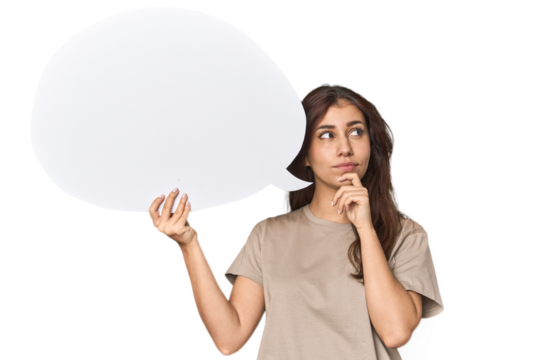 Middle Eastern woman holding comic bubble looking sideways with doubtful and skeptical expression.