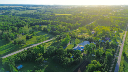 Country road US-60 BUS in rural Mountain Grove Missouri through lush greenery trees acreage, meadows and farm houses with ponds in agricultural area, peaceful countryside in Midwest, aerial view