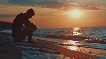 A peaceful image of a person sitting on a beach at sunset. Suitable for relaxation and travel concepts
