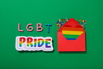 LGBT parade concept, envelope on green background.