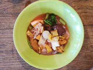 Yen ta fo with fish balls and shrimp balls in pink soupserved in a green cup. Yentafo Buffet is type of noodles. It's like fishball noodles but uses red soup from fermented bean curd.Asian food style
