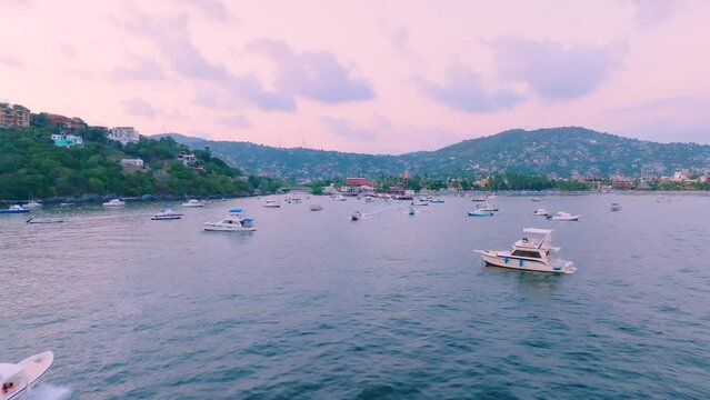Drone footage of the boats mooring and sailing near Ixtapa Pacific Coast beach resort, Mexico
