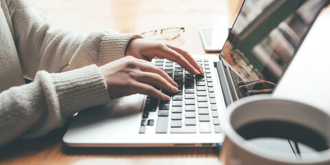 Young woman working in home on her laptop computer. Remote work concept.