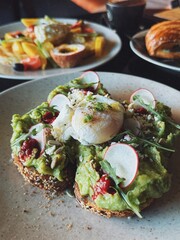 A popular breakfast. Eggs, avocado toast, coffee, salad. Instagrammable food in Bali.