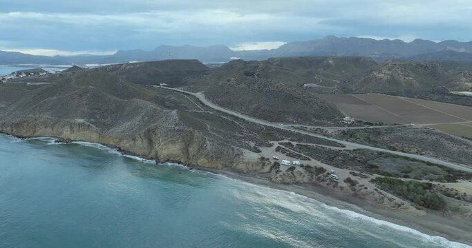 Aerial view of coastline, mountains, sea, and road at Bay de los Taray, Pulpi, Andalusia, Spain.