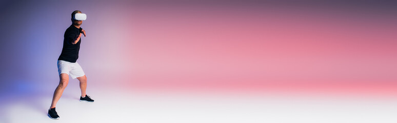 A man in black shirt and white shorts playfully moves in a dynamic display of control over virtual reality