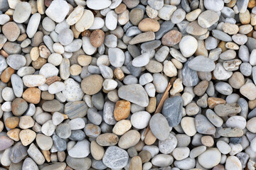 A detailed close-up image showcasing a variety of smooth river rocks in different shades and sizes, emphasizing textures