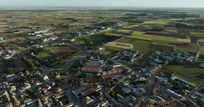 Aerial view of peaceful village and expansive farmland, San Clemente, Cuenca, Spain.