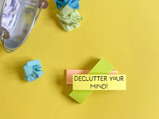 Declutter your mind on adhesive note paper background. Stock photo.