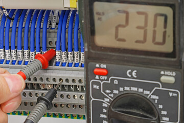 Measurement of electrical circuit parameters using a multimeter in an electrical switchboard.	
