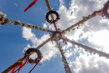 poles easter with flower decoration looking up at the sky