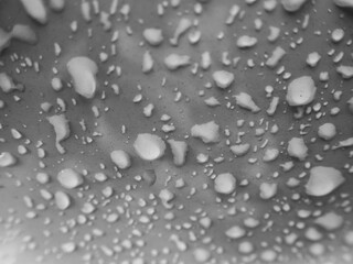 Selective focus water droplets on white car with small dust stains