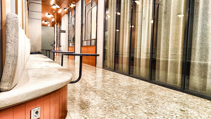 Elegant Cafe Interior With Round Tables and Bench Seating. Stylish caf? corridor with marble...