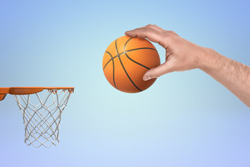 Hand scoring a basketball in a hoop