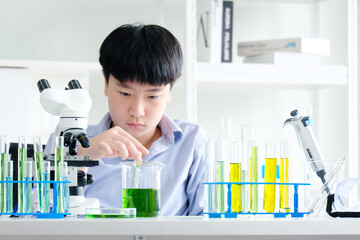 boy doing science experiment science classroom.