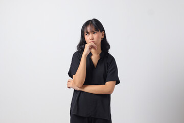 Portrait of unpleasant Asian woman in casual shirt keeping arms crossed and looking at camera with skeptical and distrustful look. Isolated image on white background