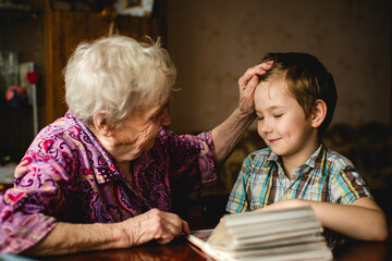 A grandmother and her grandson sharing precious moments together at home, surrounded by love and...