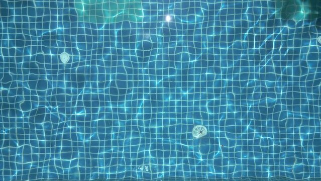 Aerial view of blue water in the pool with light reflections