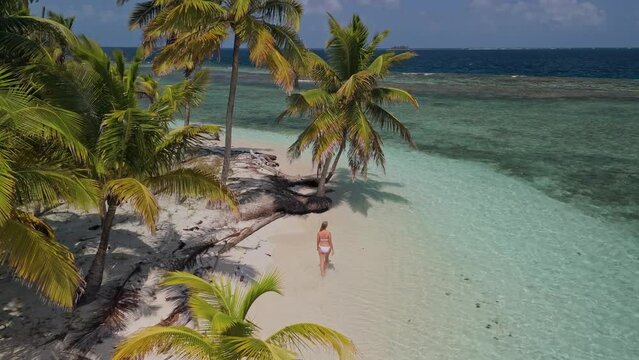 Girl waking on a beach in a remote island in Kuna Yala, Panama.