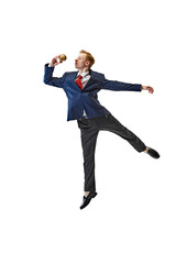 Coffee break. Young man in business attire shows his flexibility against white studio background. Work process. Concept of business, work and study, hobby, freelance, office. Ad