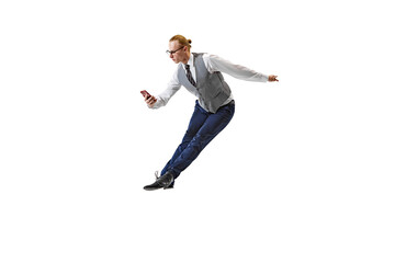 Businessman dressed smart casual outfit using phone while jumping in motion against white studio...