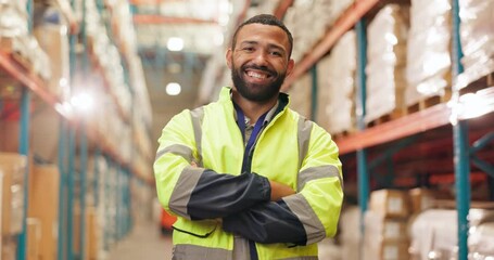 Logistics, man and face in warehouse with pride, smile and safety jacket in supply chain or freight. Male person, industrial and quality control in manufacturing, shipping or stock in trade or export