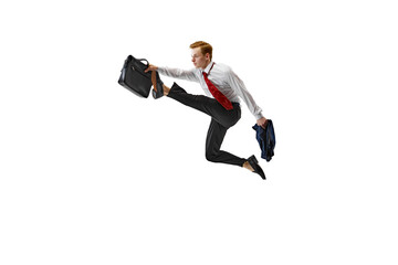 Stylish dressed man performs dynamic leap holding briefcase against white studio background....