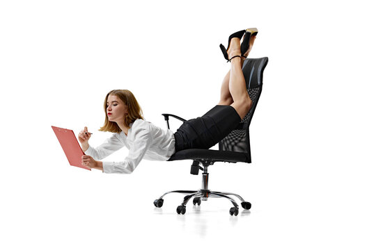 Professionalism and flexibility. Focused on work businesswoman in formal outfit resting on office chair, her legs elevated. Concept of business, work and study, hobby, freelance, office. Ad