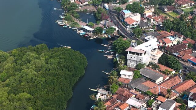 Aerial view of Negombo Lagoon with boats, houses, and mangroves, Negombo, Sri Lanka.