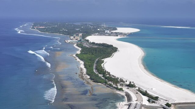 Aerial view of coastal development project with turquoise waters and palm trees, Hithadhoo, Addu Atoll, Maldives.