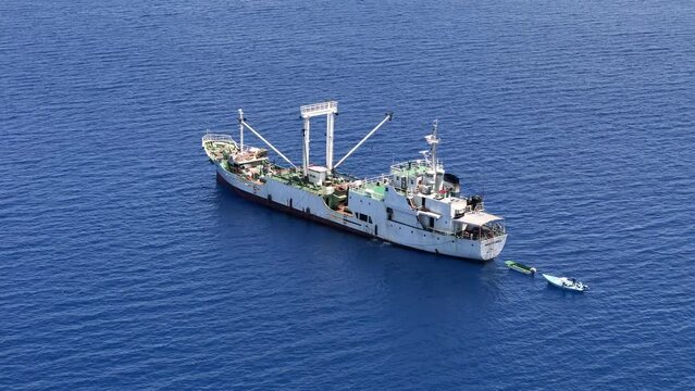 Aerial view of fishing boats and fish processing vessel in Maradhoo, Addu Atoll, Maldives.