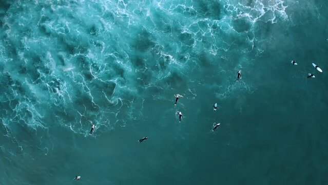 Aerial view of surfers riding waves at Bondi Beach, New South Wales, Australia.