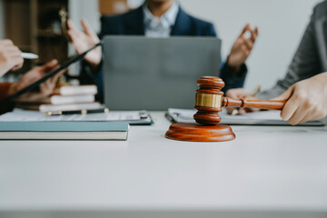Teamwork of business lawyer meeting working hard about legal legislation in courtroom to help their...