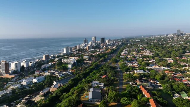 Aerial view of urban coastal cityscape with high rise buildings, roads, and trees, North Durban, South Africa.