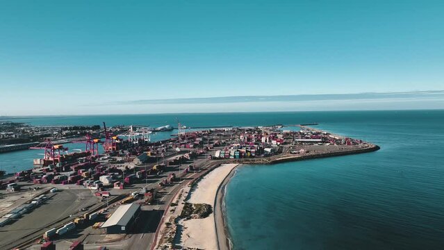 Aerial view of industrial port beach with cargo containers by the ocean, Fremantle, Western Australia, Australia.