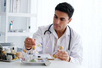 Male doctor sitting at a desk.