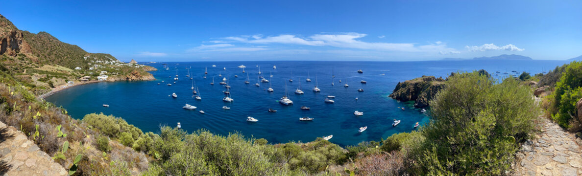 View of Drautto bay in the island of Panarea, which is part of the archipelago of the Aeolian islands, in Sicily, Italy. There are boats on the sea.