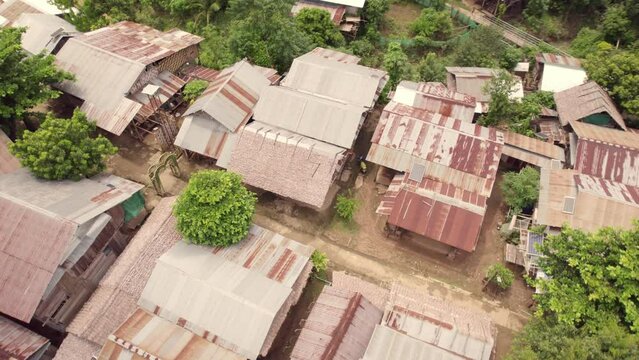Aerial view of traditional village with rustic houses and greenery, Huay Pu Keng- Kayan Village, Mae Hong Son, Thailand.