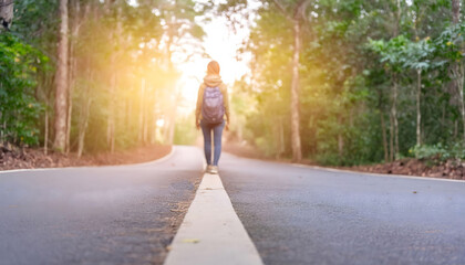 Obraz premium Woman Walking Down Middle of Road