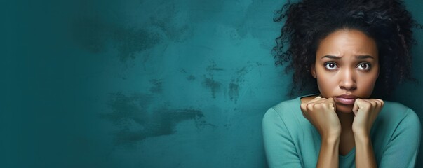 Turquoise background sad black independent powerful Woman. Portrait of young beautiful bad mood...