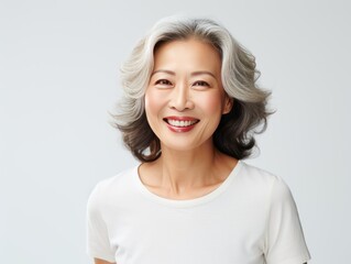 White Background Happy Asian Woman Portrait of Beautiful Older Mid Aged Mature Smiling Woman good mood Isolated Anti-aging Skin Care Face Beauty Product Banner with copyspace