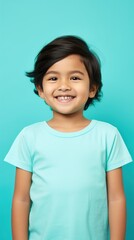 Aqua background Happy Asian child Portrait of young beautiful Smiling child good mood Isolated on backdrop ethnic diversity equality acceptance concept with copyspace 