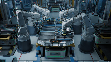 Electric Car Battery Manufacturing. Industrial Robot Arms Assemble Lithium-Ion EV Battery Pack...