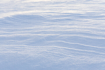 wind blown textured snow covers ground
