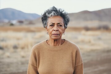 Beige background sad black American independent powerful Woman. Portrait of older mid-aged person beautiful bad mood expression girl Isolated on Background racism skin color depression 