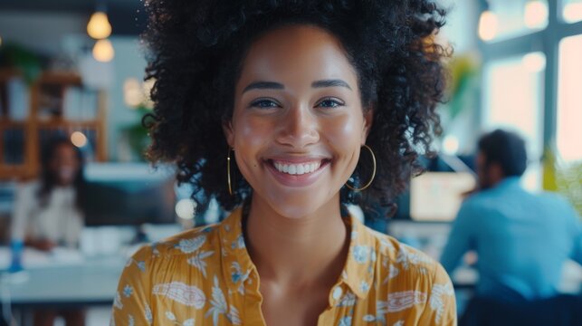 Multiethnic Gathering of Creative Colleagues Working on Computers During the Day in a Bright Office. Biracial Woman Smiling Happily After the Successful Finish of a Work Project.