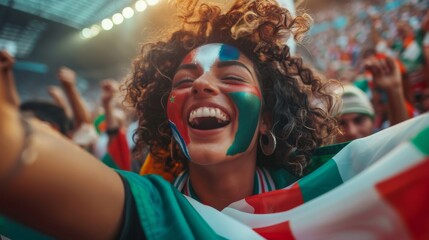 An Italian flag painted fan girl cheers on her team to victory, beating a tambourine. Fans celebrate championship victory with a goal and a celebration.