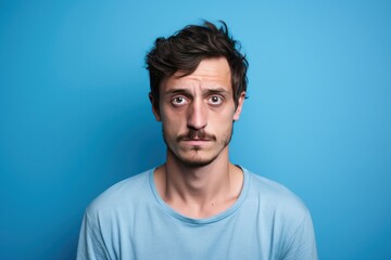 Blue background sad european white man realistic person portrait of young beautiful bad mood expression man Isolated on Background depression anxiety fear burn out health issue problem mental 